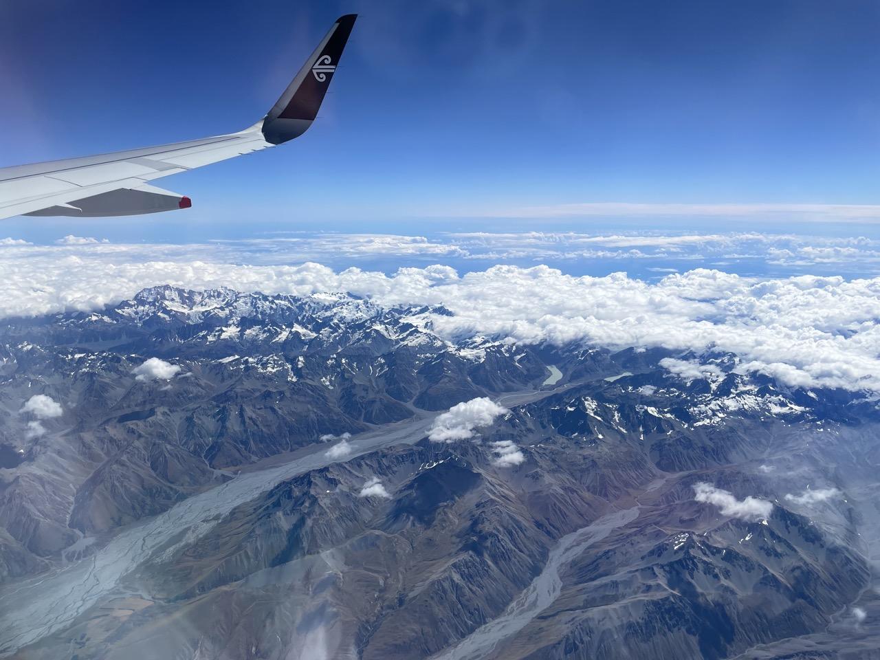 View of an aeroplane wing and mountains 